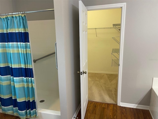 405 Central Mariners Dr, Edgewater, FL 32141 - bathroom with curtained shower, wood finished floors, and a spacious closet