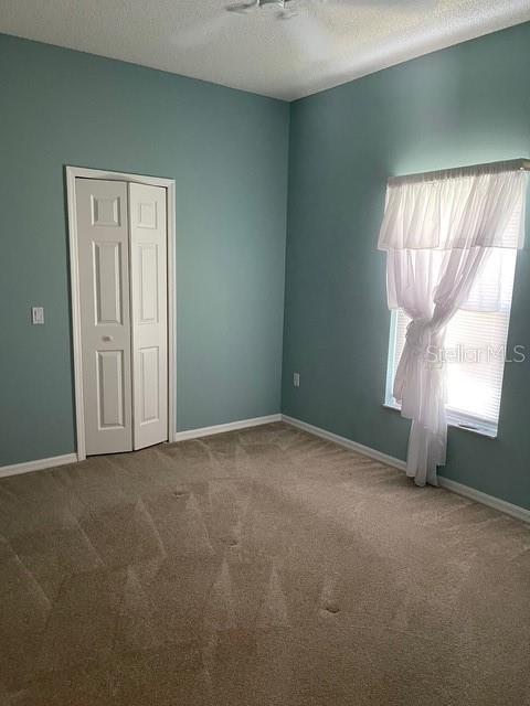 405 Central Mariners Dr, Edgewater, FL 32141 - unfurnished room with carpet and a textured ceiling