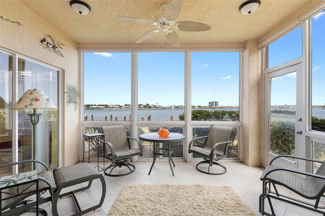 438 Bouchelle Dr Unit 105, New Smyrna Beach, FL 32169 - sunroom / solarium with a water view, plenty of natural light, tile patterned flooring, and a textured ceiling
