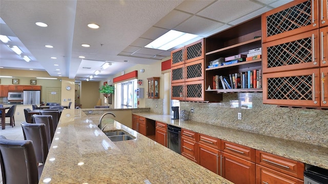 5300 S Atlantic Ave Unit 5-502, New Smyrna Beach, FL 32169 - kitchen with appliances with stainless steel finishes, light stone counters, backsplash, recessed lighting, and open floor plan