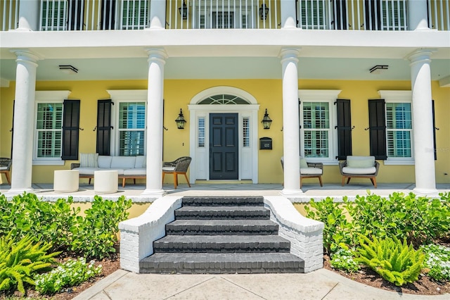 1212 S Riverside Dr, New Smyrna Beach, FL 32168 - property entrance featuring a porch and stucco siding