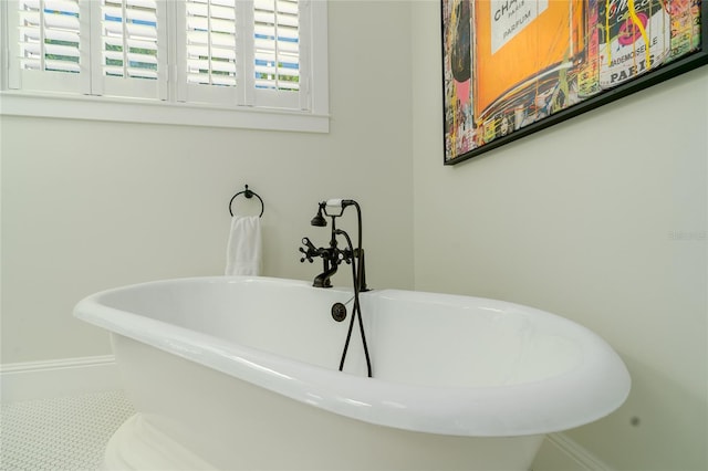 1212 S Riverside Dr, New Smyrna Beach, FL 32168 - bathroom featuring a freestanding bath and baseboards