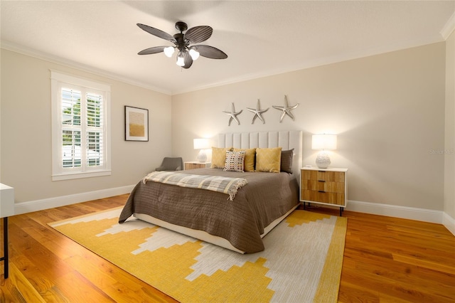1212 S Riverside Dr, New Smyrna Beach, FL 32168 - bedroom with crown molding, wood finished floors, and a ceiling fan