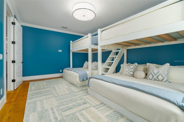 1212 S Riverside Dr, New Smyrna Beach, FL 32168 - bedroom with ornamental molding and wood finished floors