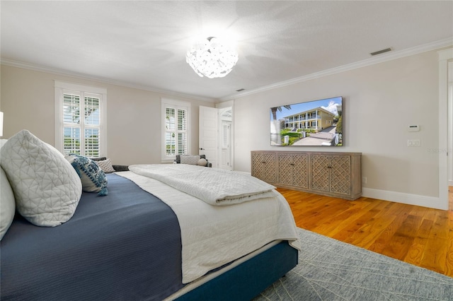 1212 S Riverside Dr, New Smyrna Beach, FL 32168 - bedroom featuring ornamental molding, wood finished floors, and a chandelier