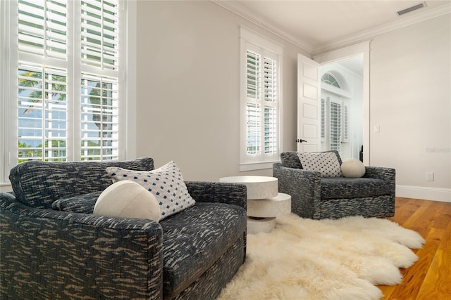 1212 S Riverside Dr, New Smyrna Beach, FL 32168 - living area featuring wood finished floors, healthy amount of natural light, and ornamental molding
