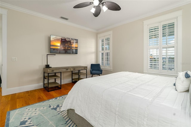 1212 S Riverside Dr, New Smyrna Beach, FL 32168 - bedroom featuring wood finished floors, ornamental molding, multiple windows, and a ceiling fan