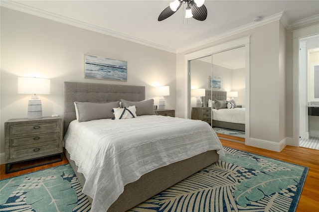 1212 S Riverside Dr, New Smyrna Beach, FL 32168 - bedroom with wood finished floors, crown molding, a closet, and ceiling fan