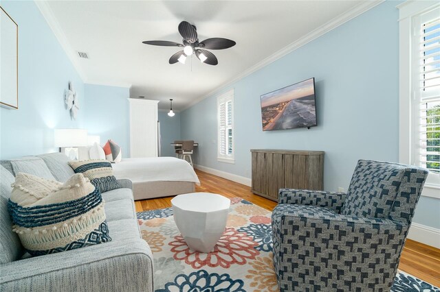 1212 S Riverside Dr, New Smyrna Beach, FL 32168 - bedroom featuring ornamental molding, light wood-style floors, and a ceiling fan