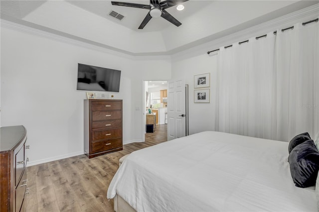 5849 Ansley Way, Mount Dora, FL 32757 - bedroom featuring light wood-type flooring, a tray ceiling, and a ceiling fan