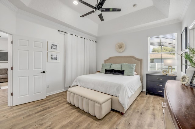 5849 Ansley Way, Mount Dora, FL 32757 - bedroom with a tray ceiling, light wood-type flooring, ornamental molding, and ceiling fan