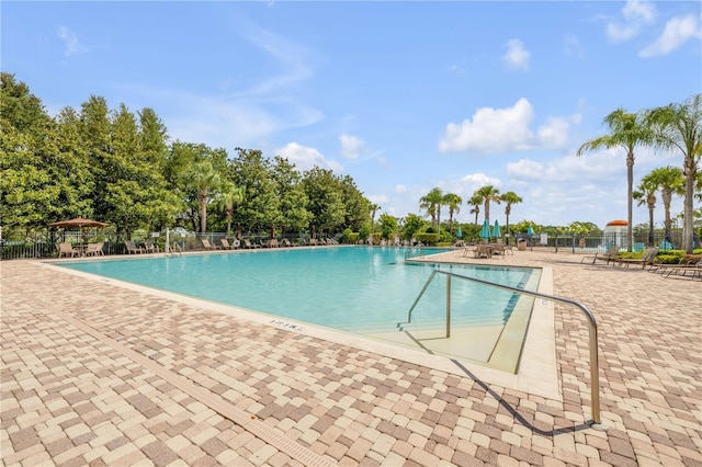 5849 Ansley Way, Mount Dora, FL 32757 - community pool featuring a patio and view of scattered trees
