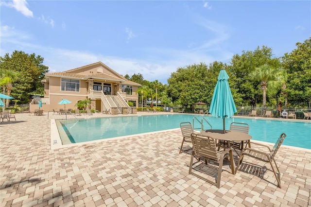 5849 Ansley Way, Mount Dora, FL 32757 - community pool featuring stairs, a patio area, and outdoor dining area