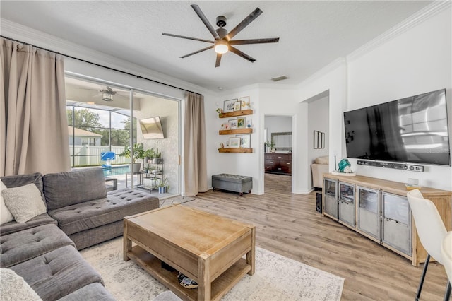 5849 Ansley Way, Mount Dora, FL 32757 - living area with a ceiling fan, ornamental molding, light wood finished floors, and a textured ceiling