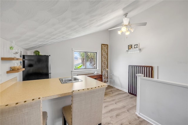 1219 Commodore Dr, New Smyrna Beach, FL 32168 - kitchen featuring freestanding refrigerator, vaulted ceiling, open shelves, a ceiling fan, and light wood finished floors