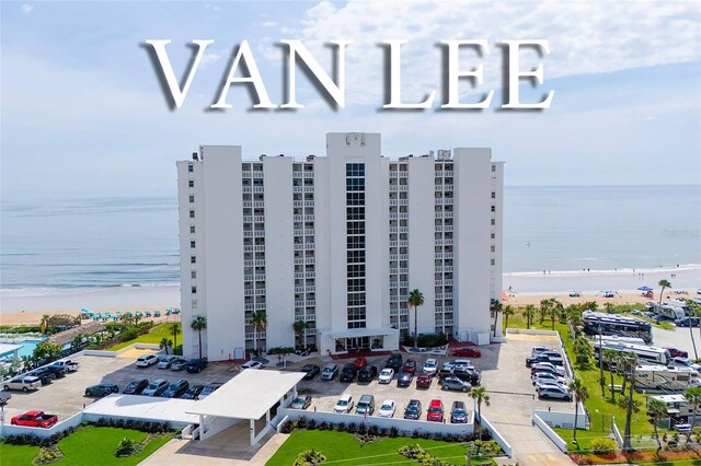 1051 Ocean Shore Blvd Unit 502, Ormond Beach, FL 32176 - view of apartment building / complex featuring view of water and beach and uncovered parking
