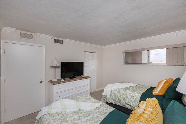1051 Ocean Shore Blvd Unit 502, Ormond Beach, FL 32176 - bedroom featuring light carpet, crown molding, and a closet
