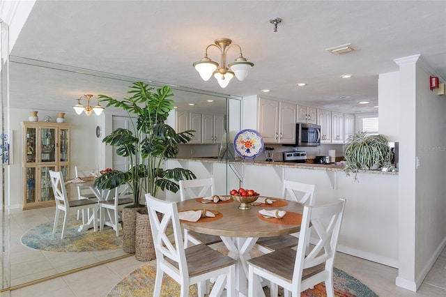 1051 Ocean Shore Blvd Unit 502, Ormond Beach, FL 32176 - dining space with a chandelier, light tile patterned floors, and recessed lighting