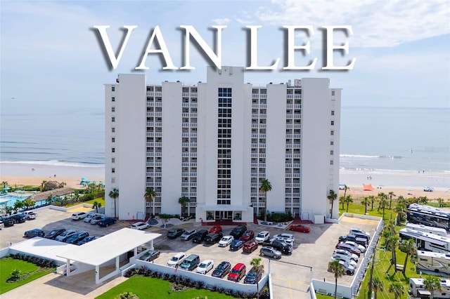 1051 Ocean Shore Blvd Unit 502, Ormond Beach, FL 32176 - view of apartment building / complex with view of water and beach and uncovered parking