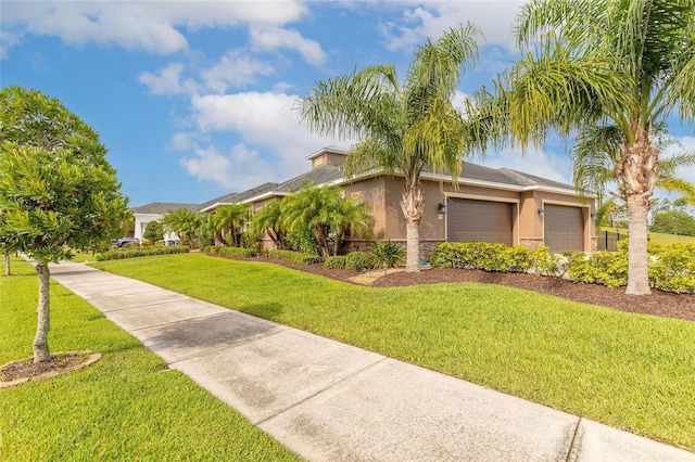 2939 Bella Flore Ter, New Smyrna Beach, FL 32168 - view of front facade with stucco siding, a garage, a front yard, and stone siding