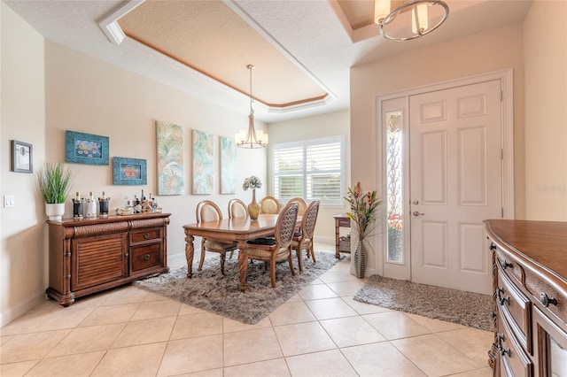 2939 Bella Flore Ter, New Smyrna Beach, FL 32168 - dining space with a chandelier, a raised ceiling, and a textured ceiling