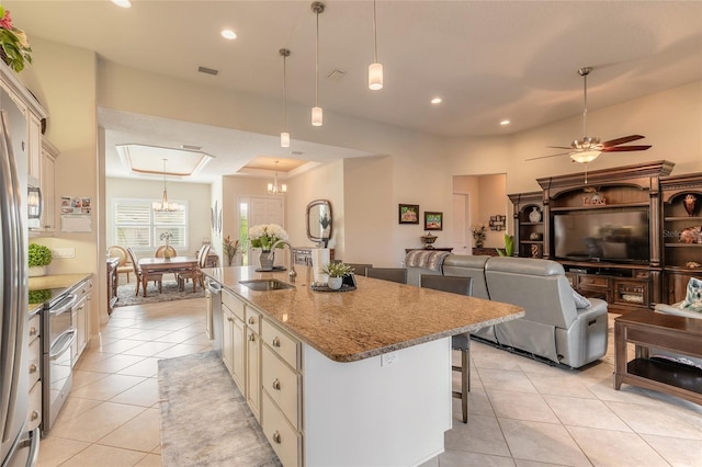 2939 Bella Flore Ter, New Smyrna Beach, FL 32168 - kitchen with a breakfast bar area, light tile patterned floors, light stone countertops, an island with sink, and pendant lighting