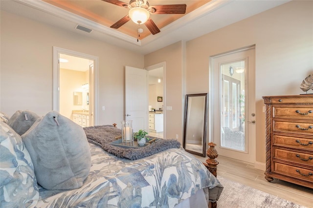 2939 Bella Flore Ter, New Smyrna Beach, FL 32168 - bedroom featuring a raised ceiling, light wood-type flooring, ensuite bathroom, and ceiling fan
