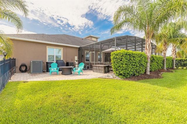2939 Bella Flore Ter, New Smyrna Beach, FL 32168 - back of property featuring a patio, stucco siding, an outdoor fire pit, and a fenced backyard