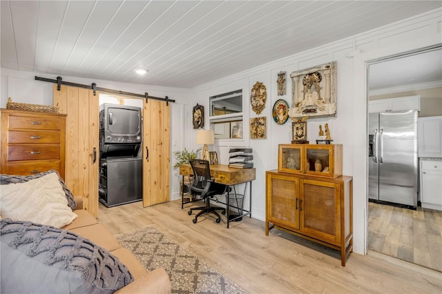402 N Orange St, New Smyrna Beach, FL 32168 - bedroom with stainless steel fridge, a barn door, ornamental molding, light wood-type flooring, and an office area