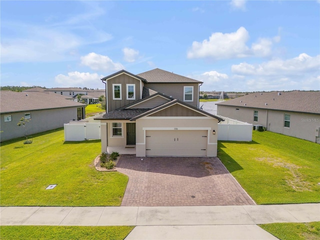 3116 Crab Trap Dr, New Smyrna Beach, FL 32168 - traditional-style house with board and batten siding, decorative driveway, a residential view, and a garage