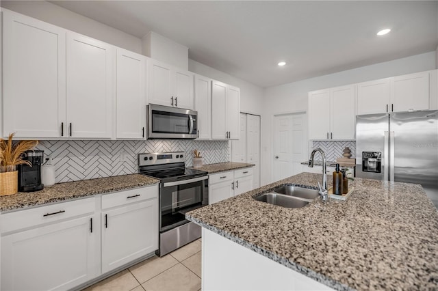 3116 Crab Trap Dr, New Smyrna Beach, FL 32168 - kitchen featuring appliances with stainless steel finishes, stone counters, decorative backsplash, white cabinetry, and recessed lighting