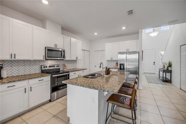 3116 Crab Trap Dr, New Smyrna Beach, FL 32168 - kitchen featuring appliances with stainless steel finishes, backsplash, light tile patterned floors, stone counters, and recessed lighting