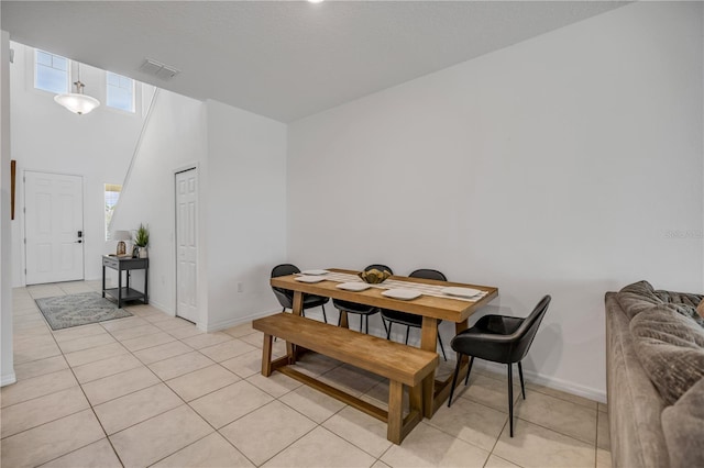 3116 Crab Trap Dr, New Smyrna Beach, FL 32168 - dining area featuring light tile patterned flooring and a towering ceiling