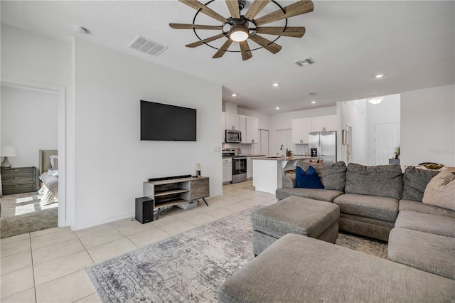 3116 Crab Trap Dr, New Smyrna Beach, FL 32168 - living room with a ceiling fan, light tile patterned flooring, and recessed lighting