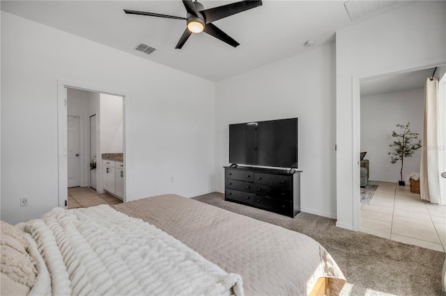 3116 Crab Trap Dr, New Smyrna Beach, FL 32168 - bedroom featuring light tile patterned flooring, light carpet, a wood stove, and a ceiling fan