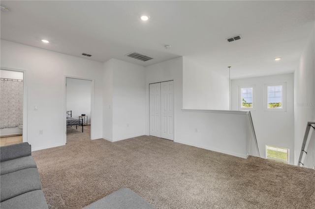 3116 Crab Trap Dr, New Smyrna Beach, FL 32168 - unfurnished living room with carpet floors and recessed lighting
