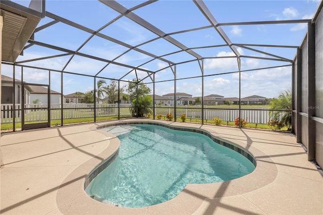 3116 Crab Trap Dr, New Smyrna Beach, FL 32168 - view of swimming pool with a patio, a residential view, a fenced backyard, glass enclosure, and a water view