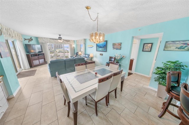 2967 S Atlantic Ave Unit 508, Daytona Beach, FL 32118 - dining room featuring a textured ceiling, a chandelier, light tile patterned floors, and ceiling fan