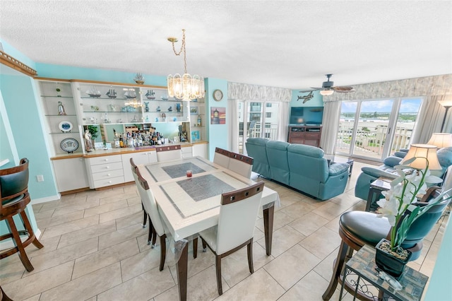 2967 S Atlantic Ave Unit 508, Daytona Beach, FL 32118 - dining area featuring a chandelier, a textured ceiling, a ceiling fan, and light tile patterned flooring