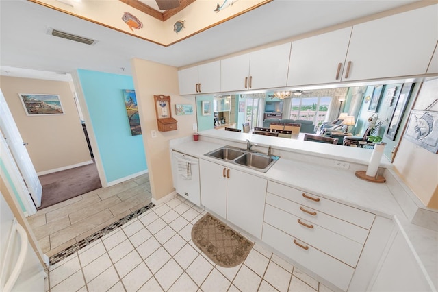 2967 S Atlantic Ave Unit 508, Daytona Beach, FL 32118 - kitchen featuring light countertops, white dishwasher, light tile patterned floors, and white cabinets