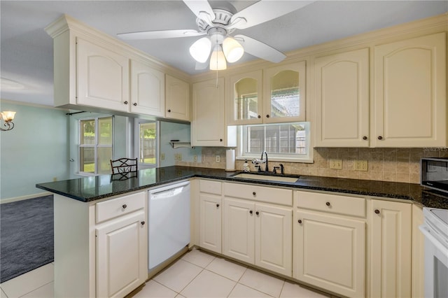 2416 Pine Tree Dr, Edgewater, FL 32141 - kitchen featuring white dishwasher, a peninsula, backsplash, and stainless steel microwave