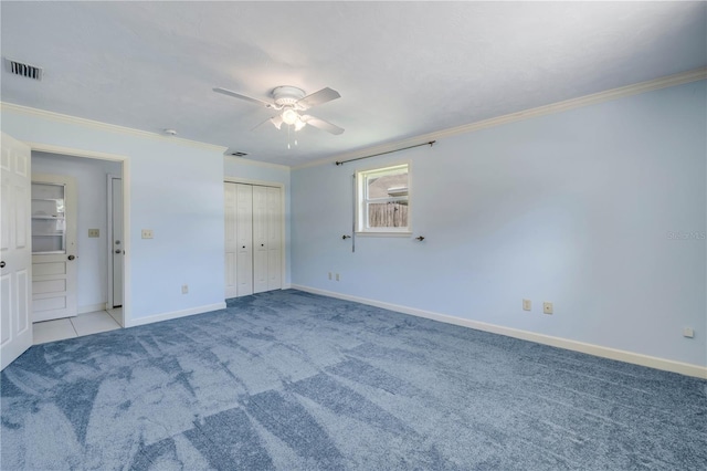 2416 Pine Tree Dr, Edgewater, FL 32141 - unfurnished bedroom with carpet flooring, crown molding, a ceiling fan, and a closet