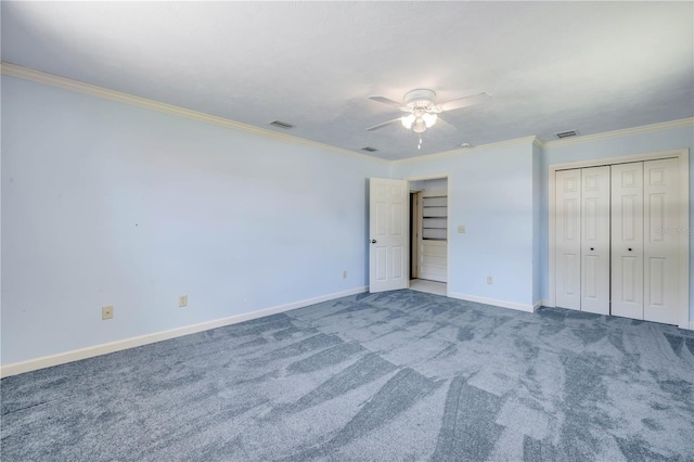 2416 Pine Tree Dr, Edgewater, FL 32141 - unfurnished bedroom featuring ornamental molding, carpet, a ceiling fan, and a closet
