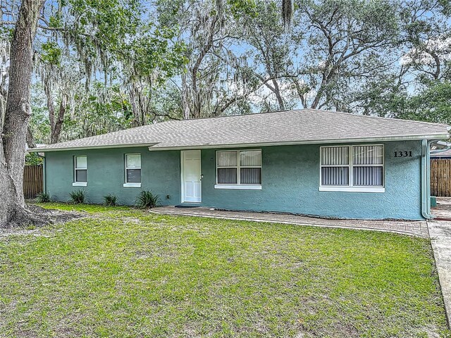 1331 Needle Palm Dr, Edgewater, FL 32132 - view of front facade with stucco siding and a shingled roof