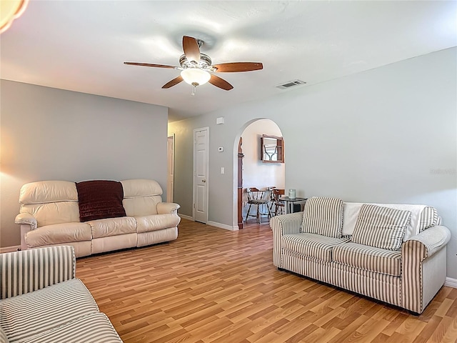 1331 Needle Palm Dr, Edgewater, FL 32132 - living room featuring arched walkways, ceiling fan, and light wood-type flooring