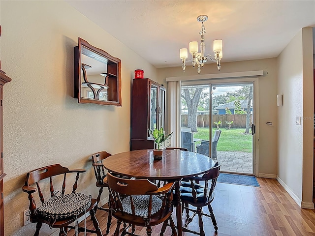 1331 Needle Palm Dr, Edgewater, FL 32132 - dining area with a chandelier and light wood-style floors