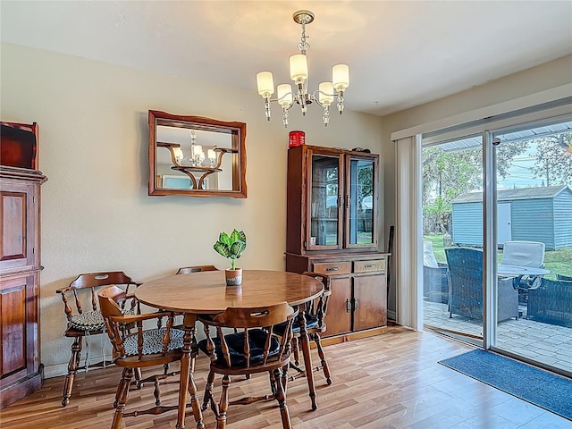 1331 Needle Palm Dr, Edgewater, FL 32132 - dining area with a chandelier and light wood-style floors
