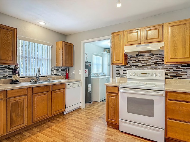 1331 Needle Palm Dr, Edgewater, FL 32132 - kitchen with under cabinet range hood, white appliances, independent washer and dryer, decorative backsplash, and water heater