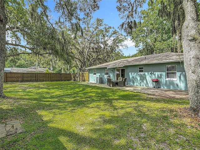 1331 Needle Palm Dr, Edgewater, FL 32132 - rear view of house featuring stucco siding, a fenced backyard, and a patio area