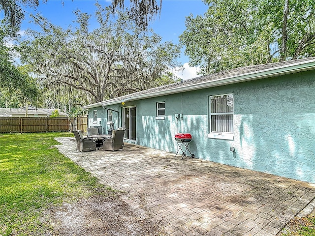 1331 Needle Palm Dr, Edgewater, FL 32132 - back of property with stucco siding and a patio area
